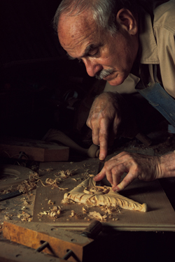 Woodworker creating an intricate design.