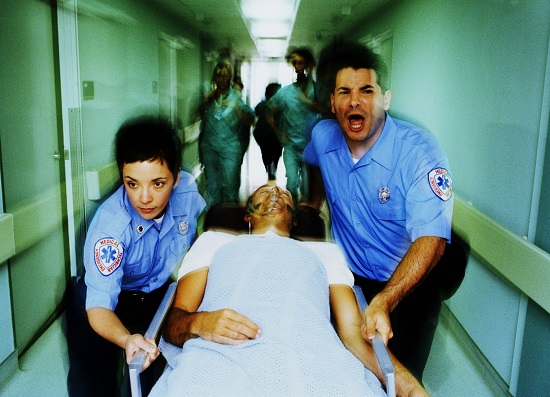 EMTs rushing a patient to the hospital