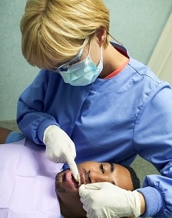 Dental hygienist cleaning teeth