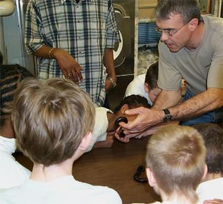 George Keeney shows a millipede to students.
