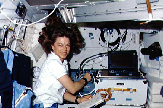 Bonnie Dunbar conducts experiments aboard a space shuttle. Photo courtesy of NASA.