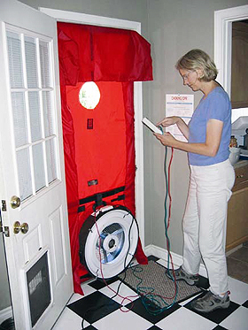 Energy auditor conducting blower-door test