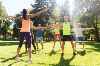 Group of people outdoors with a fitness instructor.