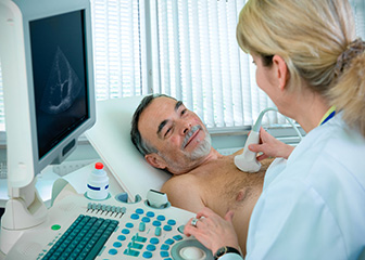 Diagnostic medical sonographer working with a patient